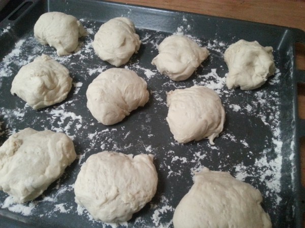 Pieces of bürli dough on floured backing tray.